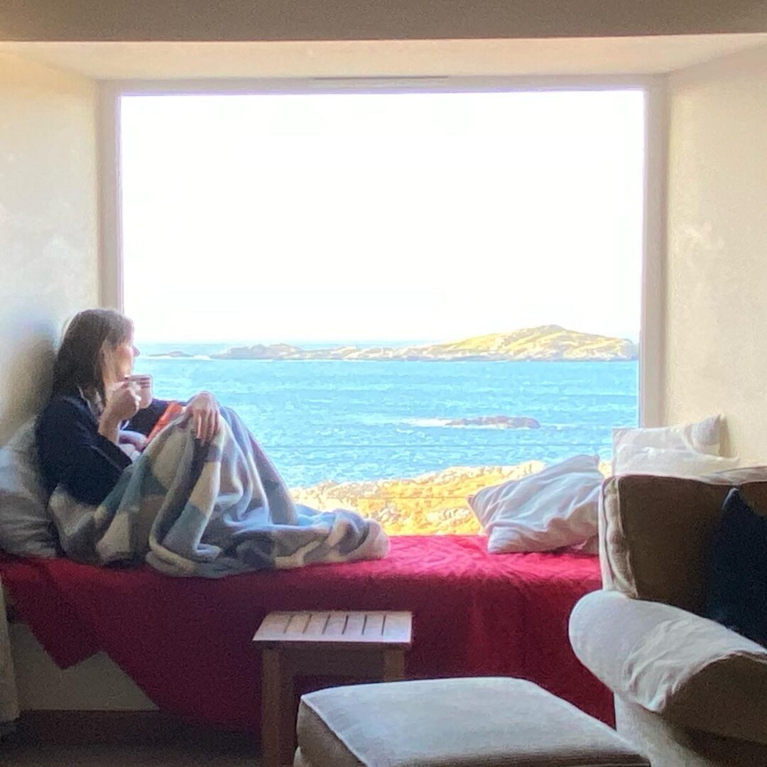 Reading book with blanket, overlooking Harris